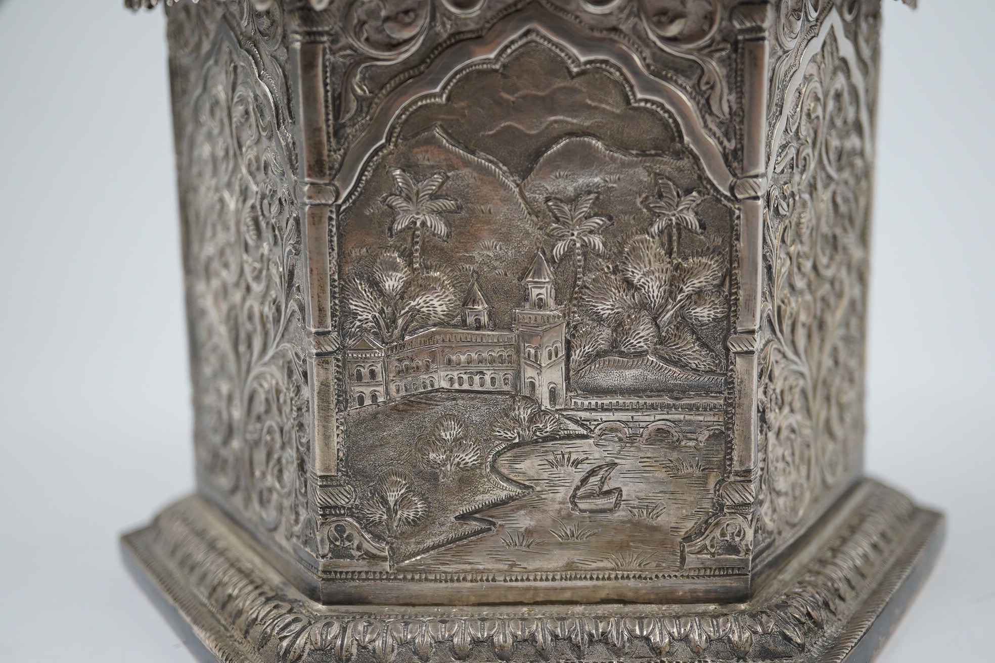 An early 20th century Indian embossed silver hexagonal box with fluted domed hinged cover